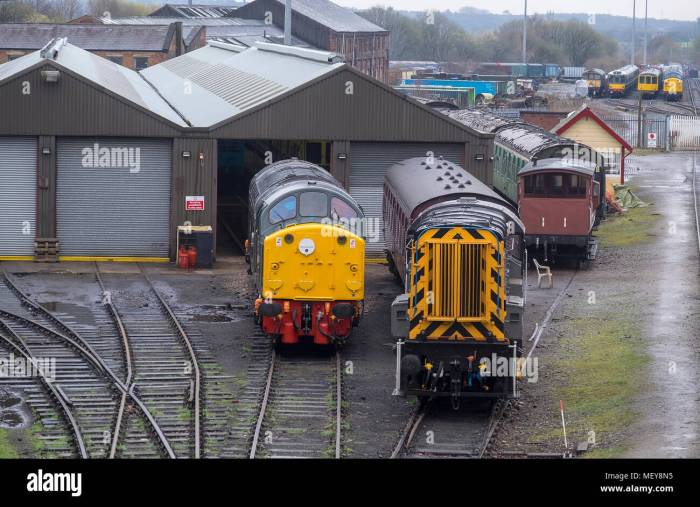 A train engine pulls a train with three cars